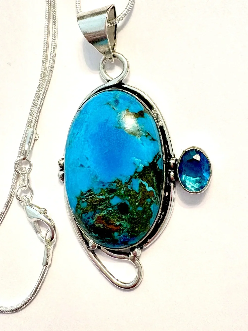 2 1/2 inch, 925 marked, Turquoise and Blue Topaz pendant on a silver chain.